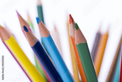 Bunch of color pencils in a stand over the white background