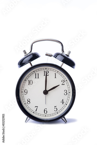 Black vintage alarm clock over the white background