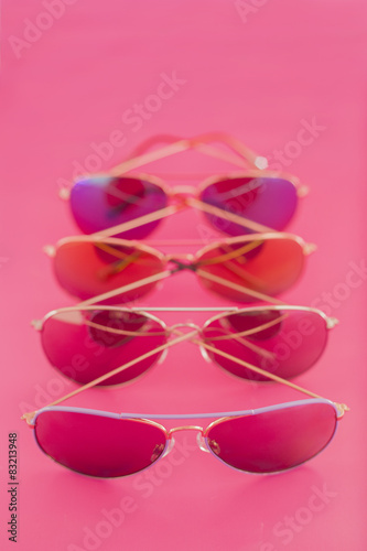 Collection of aviator stile sunglasses on pink background