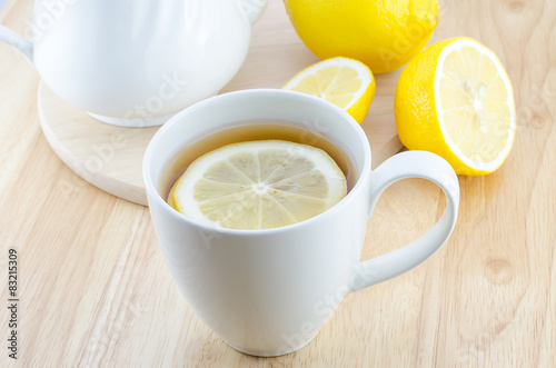 Cup of lemon tea on wooden table