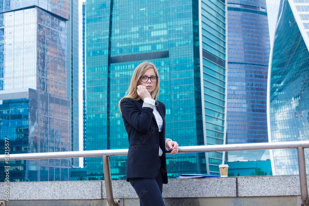Business woman on the background of skyscrapers on the phone Business woman on the background of skyscrapers on the phone