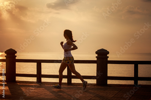 asian girl runs at sunrise