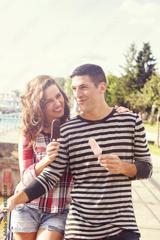 Young couple eating ice cream on a sunny day