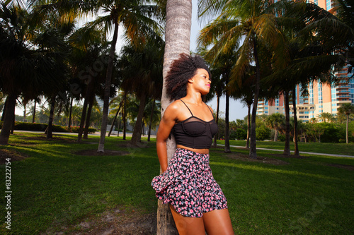 Woman posing on a tree in the park