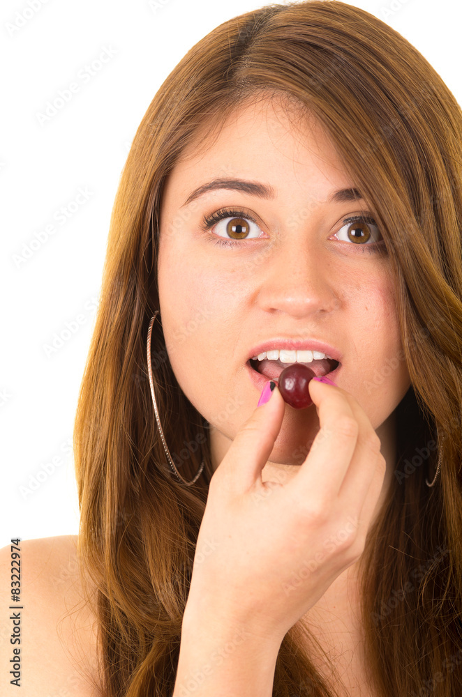Beautiful young supersticious woman eating grapes Beautiful young supersticious woman eating grapes