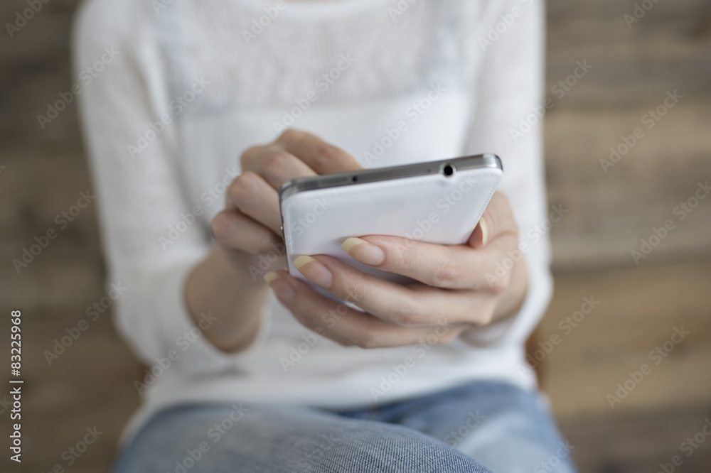 Women send an email with a smart phone Women send an email with a smart phone