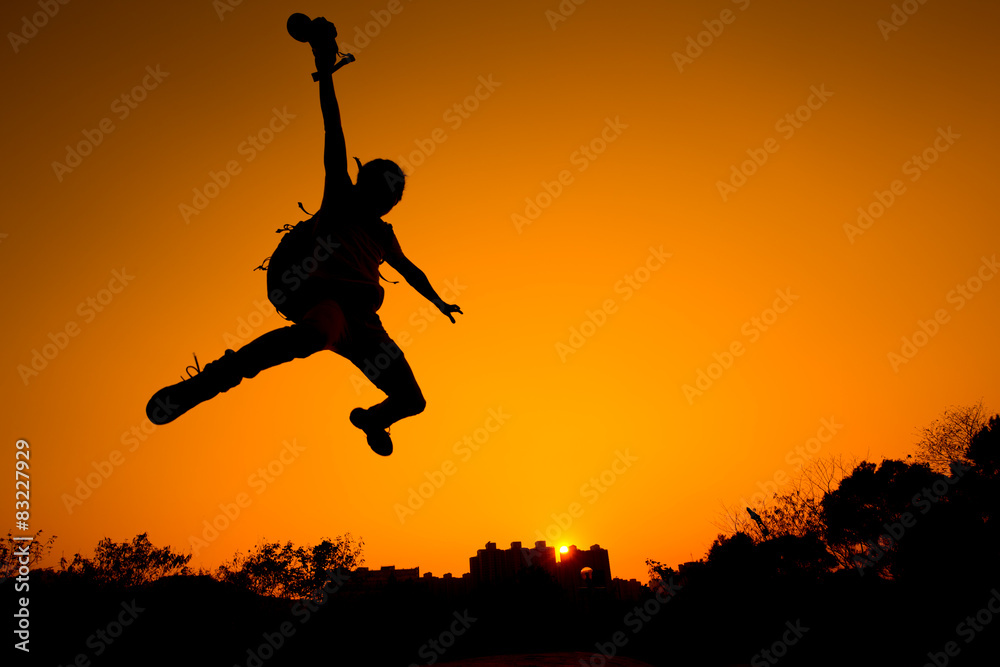 Silhouette of Man jumping - color tone tuned Silhouette of Man jumping - color tone tuned