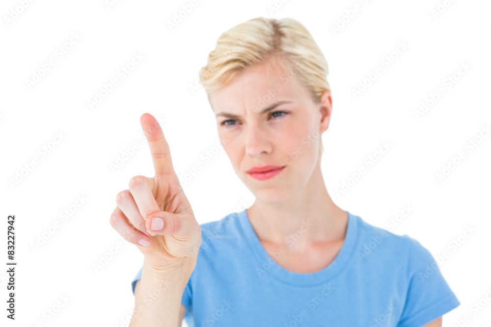 Serious blonde woman pointing with her finger Serious blonde woman pointing with her finger