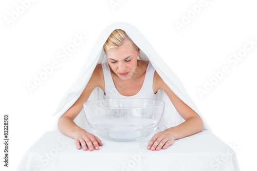 Принти на полотні Blonde woman inhaling herbal medicine