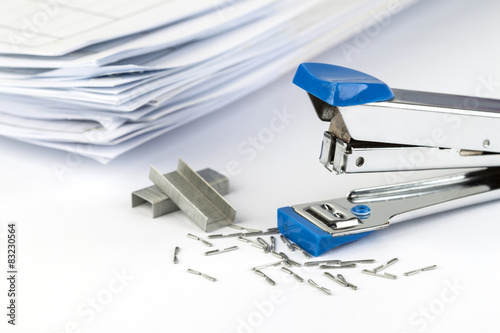 stapler and pile of papers. photo