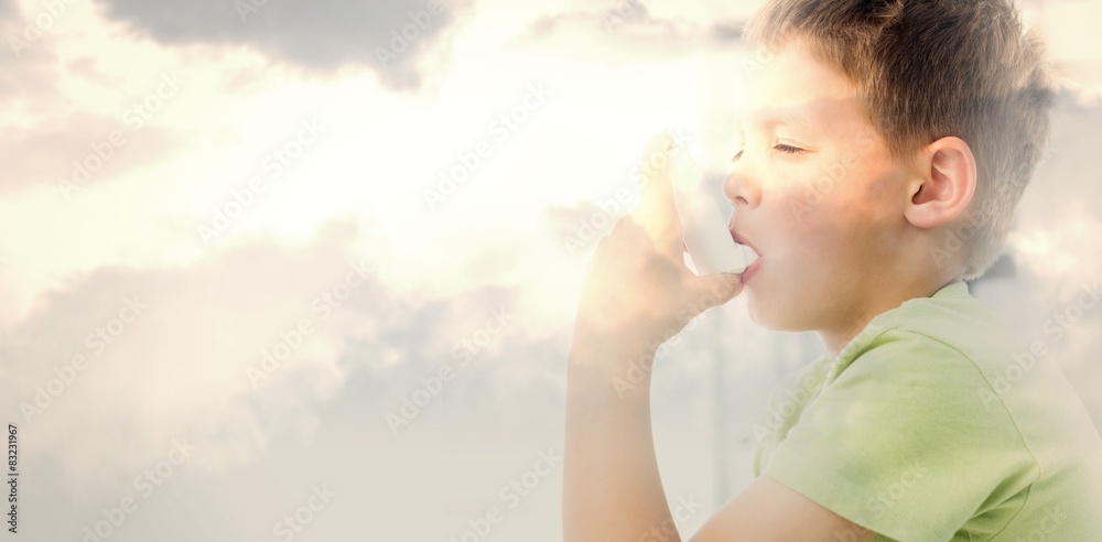 Composite image of boy using an asthma inhaler in clinic Composite image of boy using an asthma inhaler in clinic