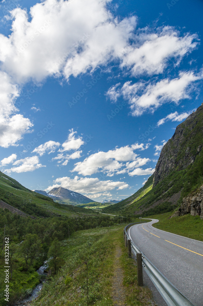 Curvy and lonely road between norwegian hills