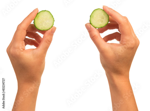 Hands with cucumber slices