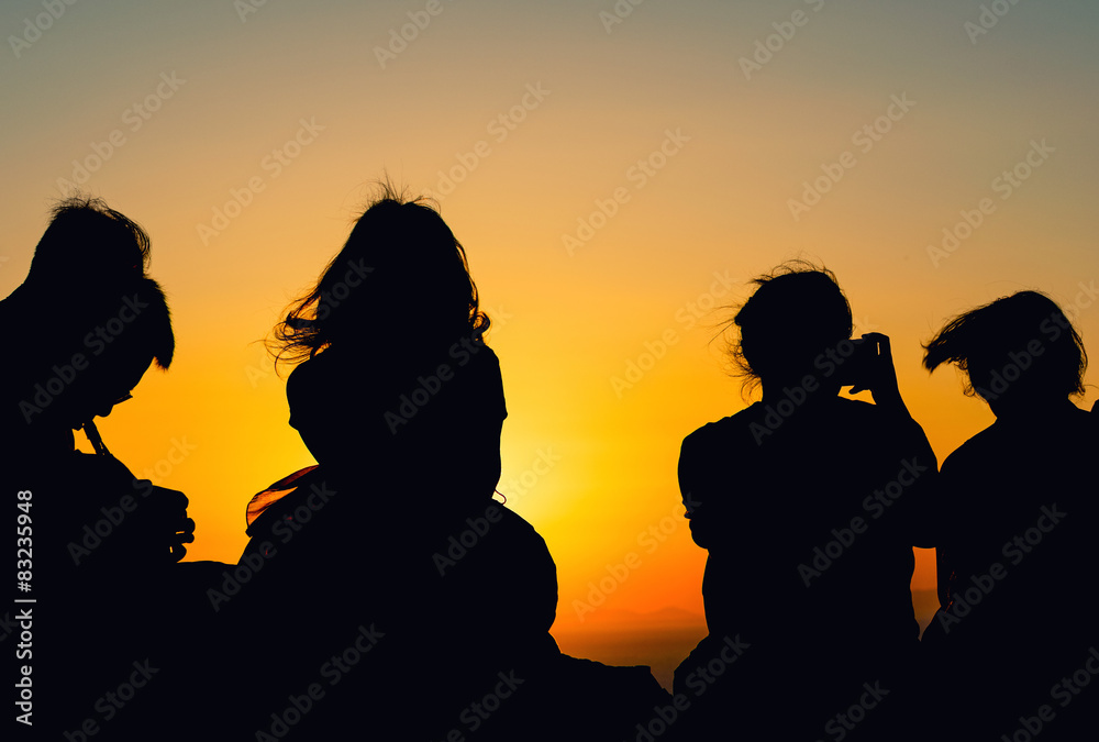 Silhouettes of people watching sunset. Relax concept