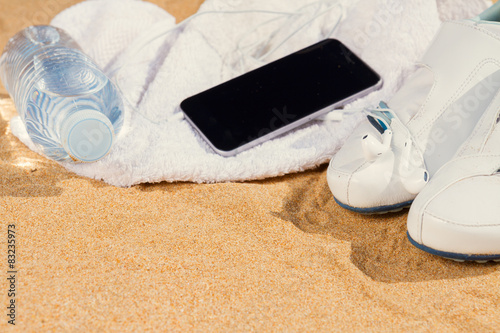 white sneakers in sand 