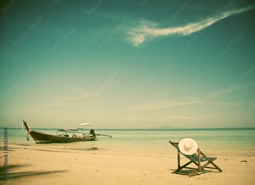Exotic beach holiday background with beach chair and long tail b