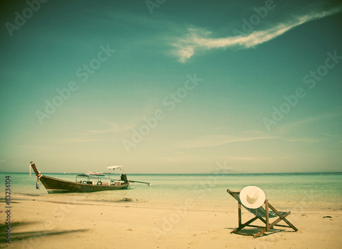 Fototapeta Naklejka Na Ścianę i Meble -  Exotic beach holiday background with beach chair and long tail b