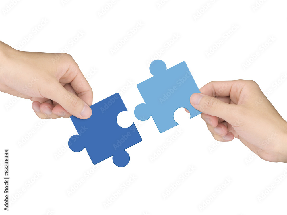 cooperation concept: hands holding jigsaw pieces cooperation concept: hands holding jigsaw pieces