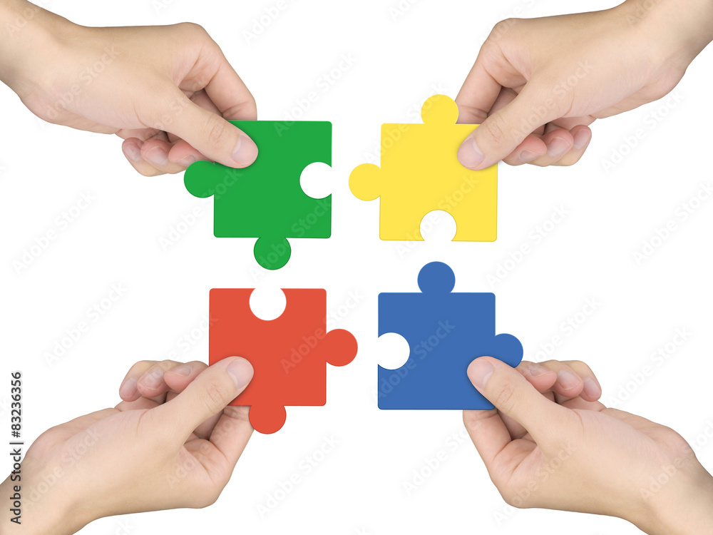 cooperation concept: hands holding jigsaw pieces cooperation concept: hands holding jigsaw pieces