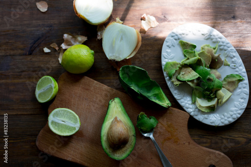 preparation guacamole ingridients on table lime, onion, avocado