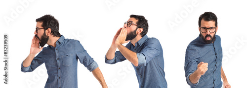 Young hipster man pointing and shouting
