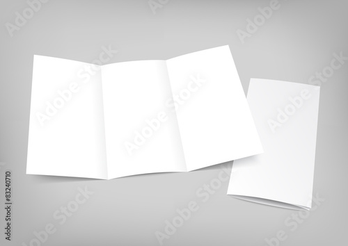 Blank white folding paper flyer on gray background. photo
