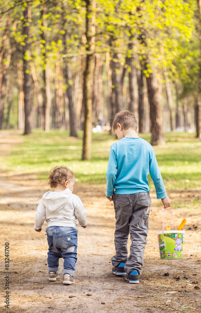 Fototapeta premium little brother and sister go to the forest