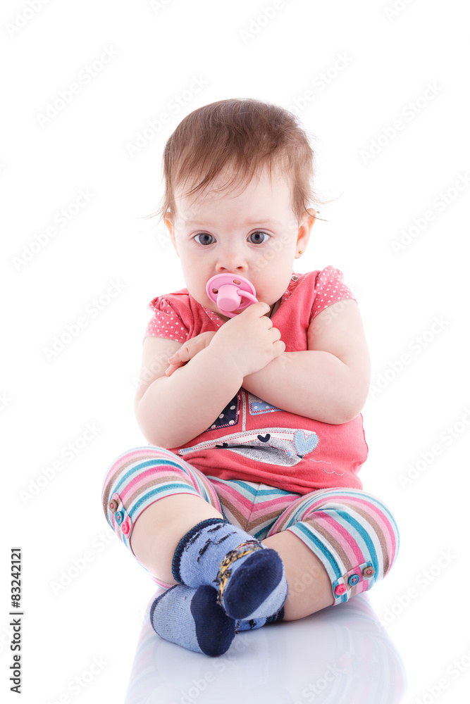 The girl is one year in dress sitting on a background. The girl is one year in dress sitting on a background.