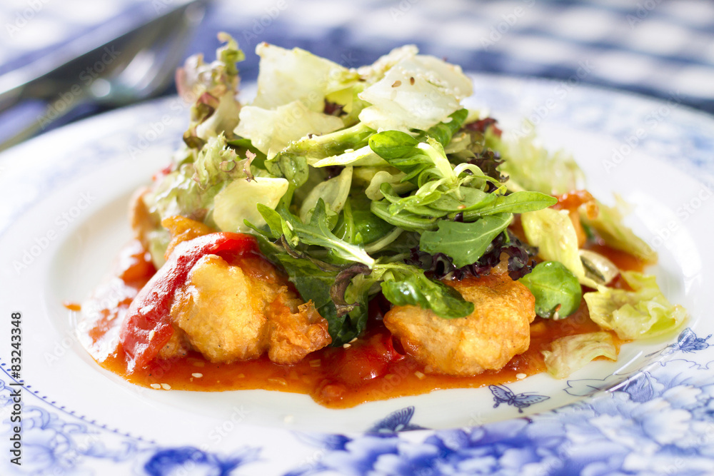 Salad with fried fish fillet, red pepper and salad mix Salad with fried fish fillet, red pepper and salad mix
