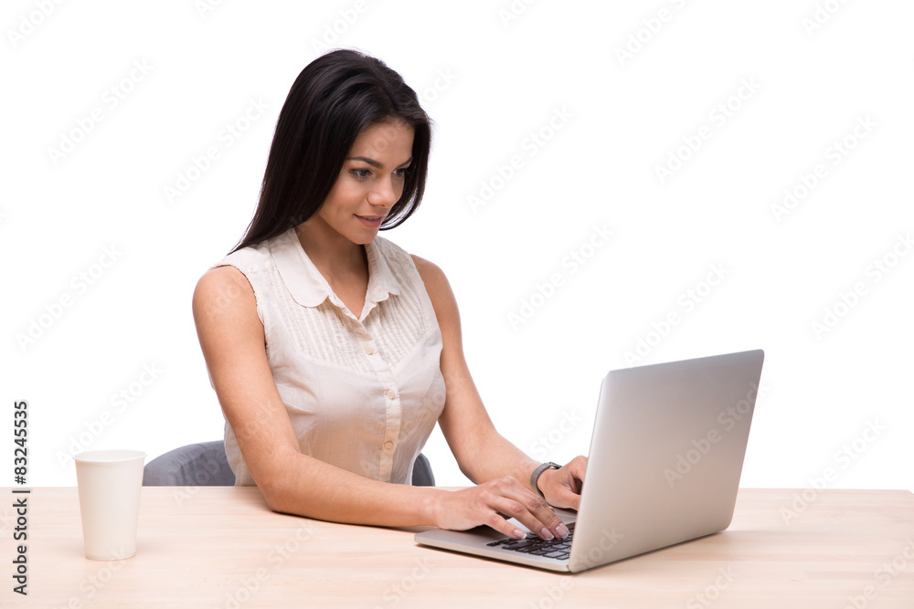 Smiling businesswoman sitting at the table with laptop Smiling businesswoman sitting at the table with laptop