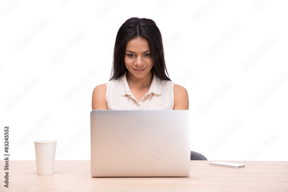 Happy businesswoman sitting at the table with laptop Happy businesswoman sitting at the table with laptop