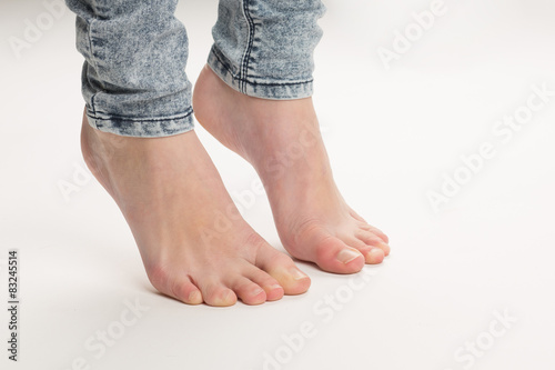 Two Bare Feet Standing TipToe On The Floor