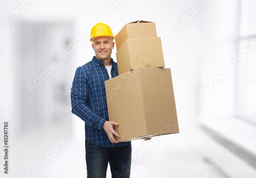 smiling man in helmet with cardboard boxes