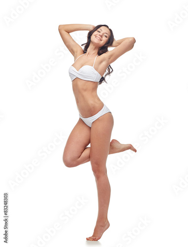 happy young woman in white bikini swimsuit