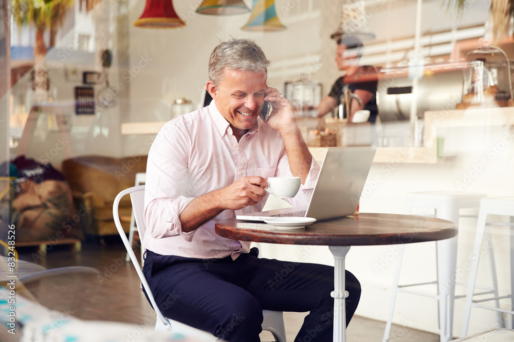 Middle aged man sitting in a cafe Middle aged man sitting in a cafe
