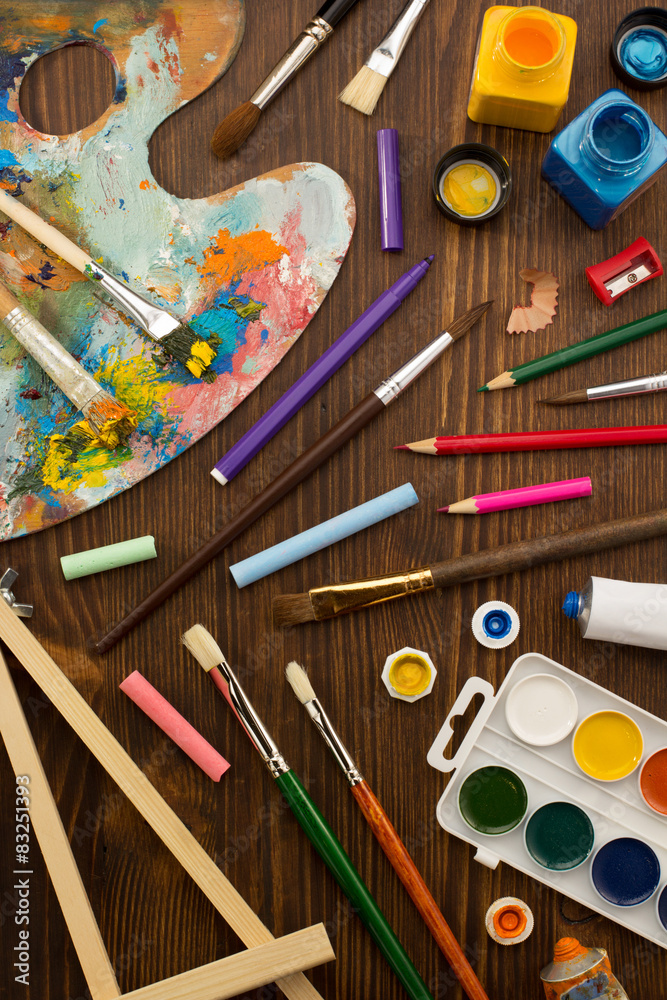 Naklejka premium paint supplies and brush on wood