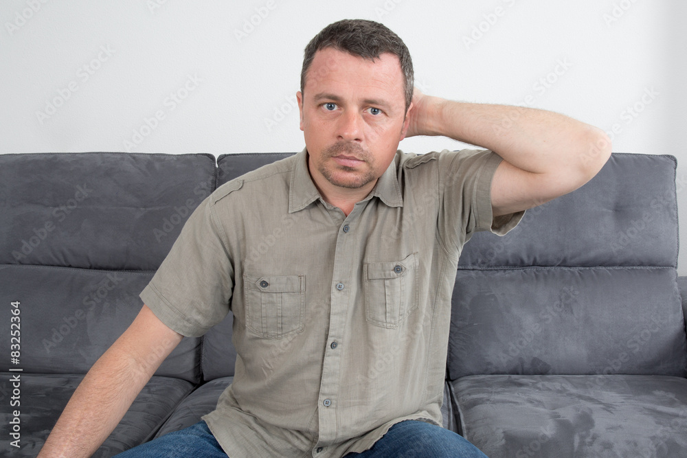Relaxed  man sitting on sofa in the house