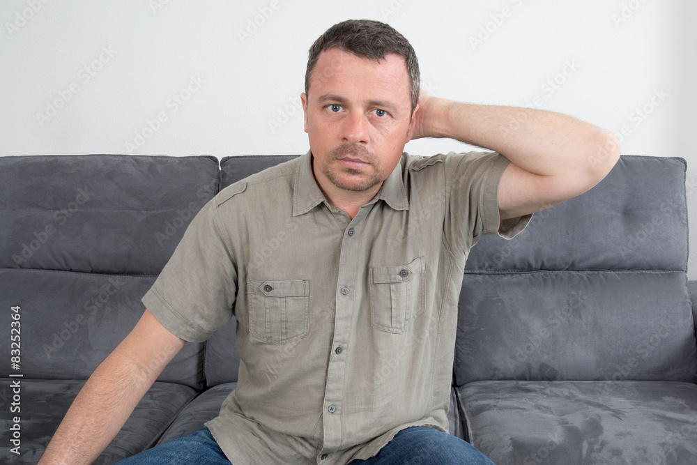 Relaxed man sitting on sofa in the house Relaxed man sitting on sofa in the house