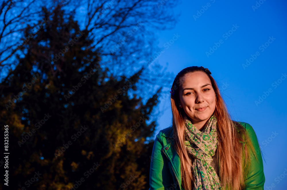 Beautiful girl at sunset next to a pine Beautiful girl at sunset next to a pine