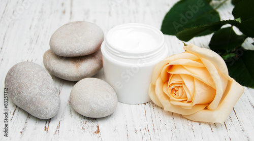 cosmetic cream with spa stones and rose