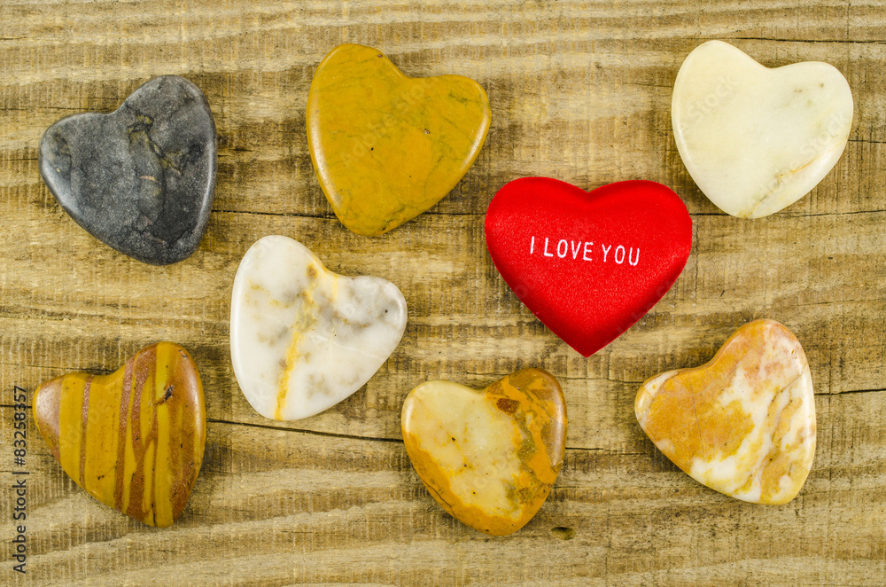 Many different hearts on wooden table Many different hearts on wooden table