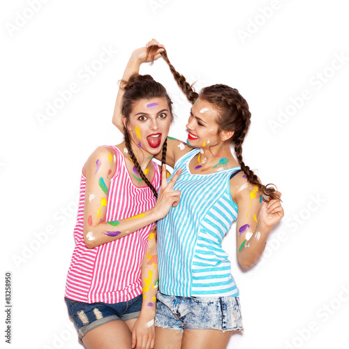 Two crazy painted women friends having fun