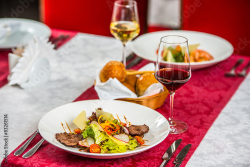 Grilled steak, grilled vegetables and bread on table,