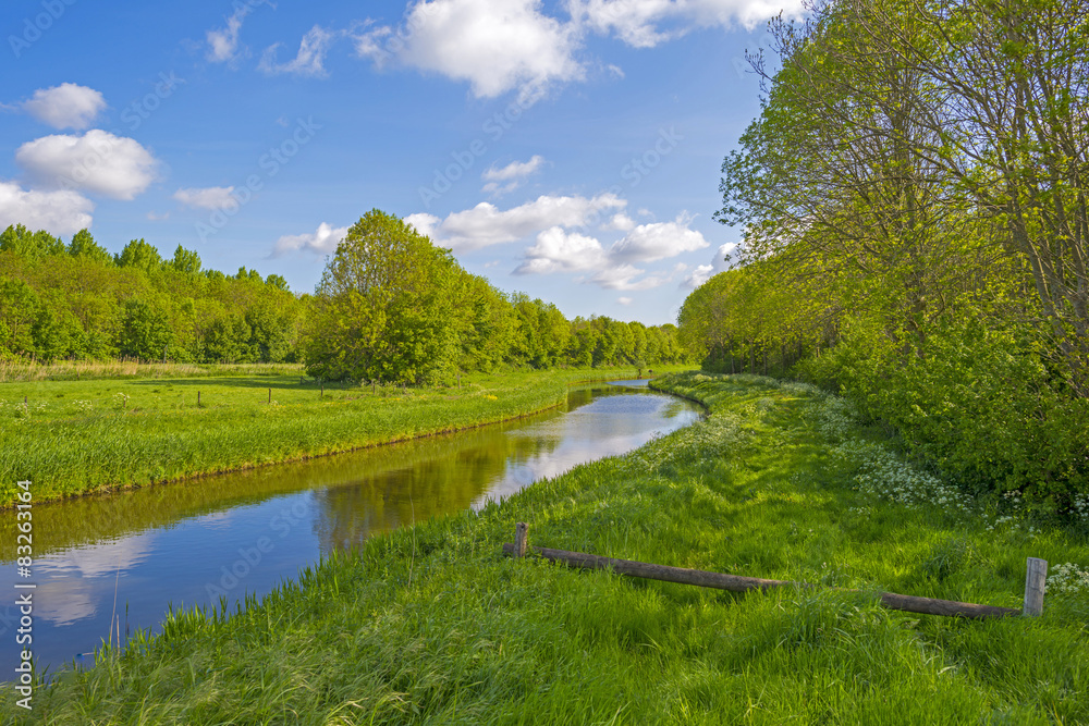 Canal meandering through the countryside in spring Canal meandering through the countryside in spring