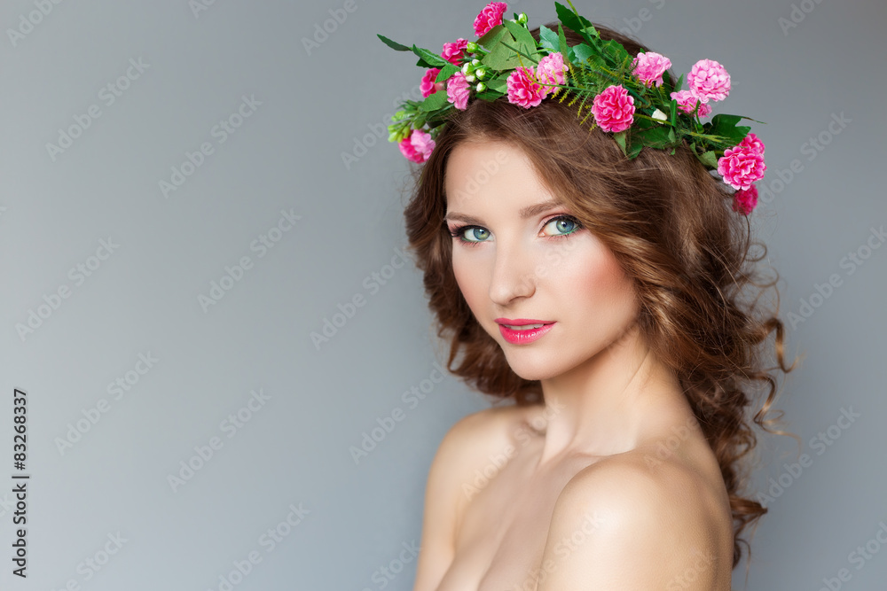 beautiful girl with wreath of flowers with bare shoulders