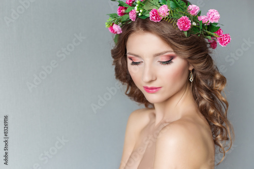 beautiful sexy girl with a wreath of flowers with bare shoulders