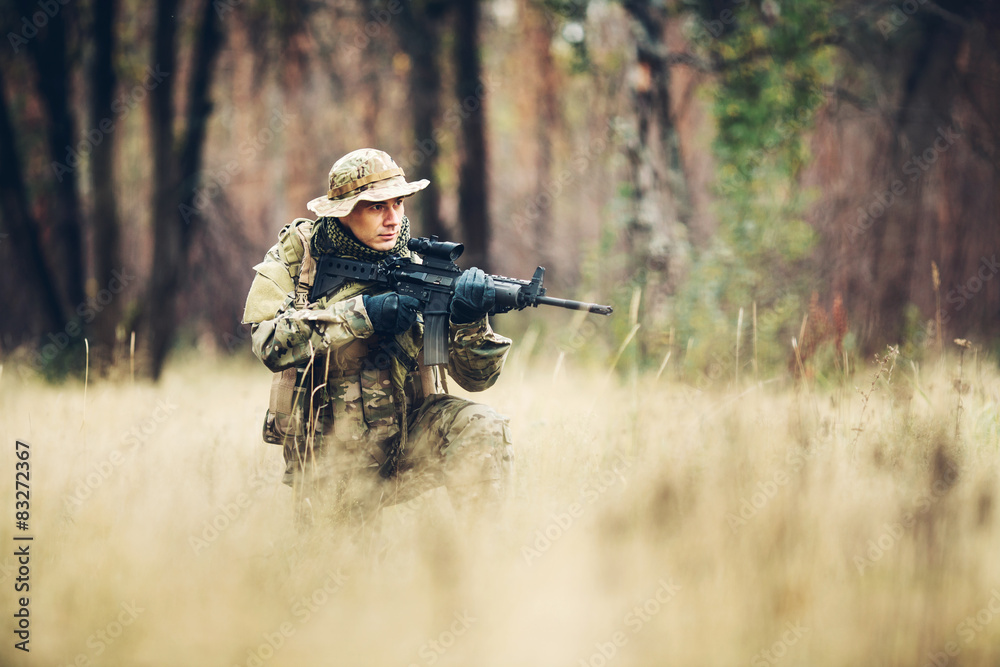 soldier with rifle in the forest soldier with rifle in the forest