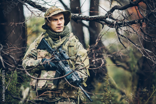 soldier with rifle in the forest