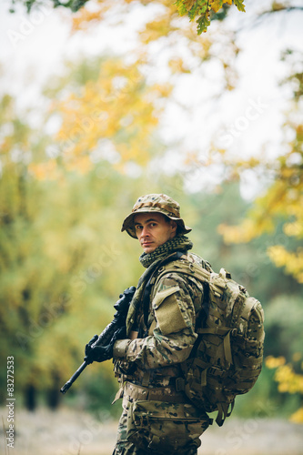 soldier with rifle in the forest