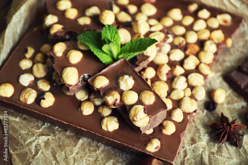 Delicious chocolates with spices on table, closeup